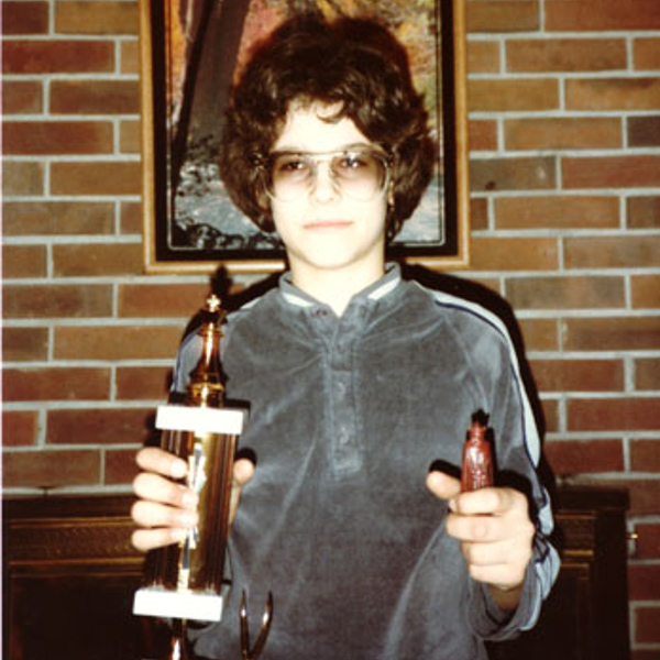 1980s youth with velour shirt and chess trophy