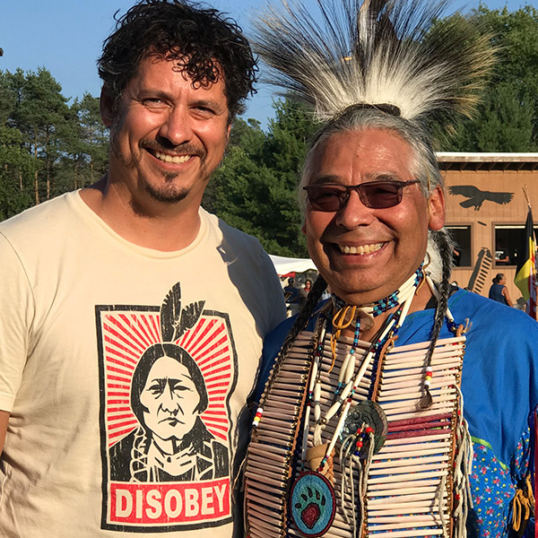 Native American in regalia with grown son