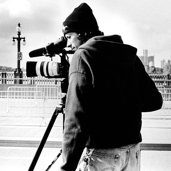 Man behind video camera shooting