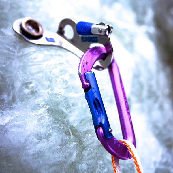Close up of ice climbing screw with carabiner
