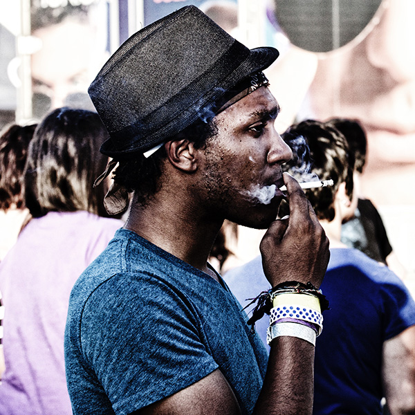 Youth in hat smoking