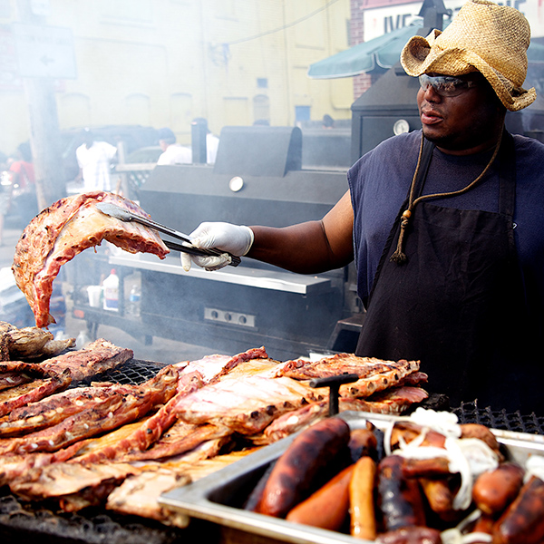 Street cook at grill cooking ribs in Eastern Market Detroit