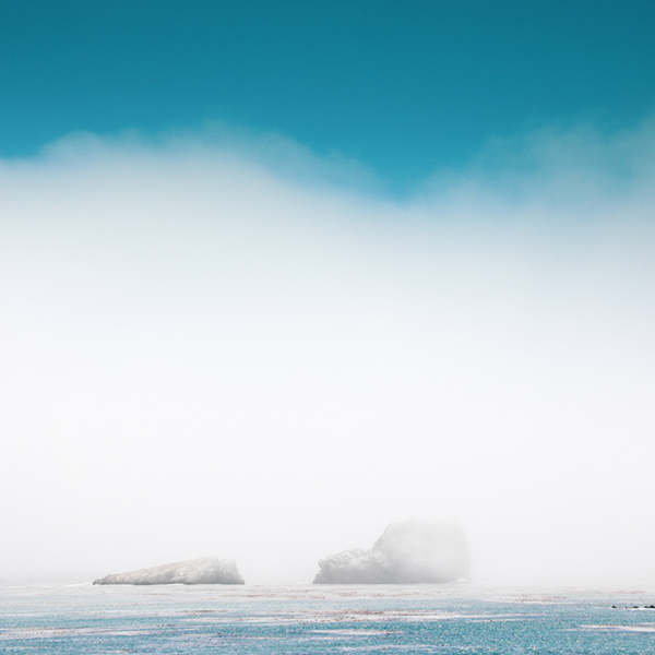 Two rock islands shrouded in mist in the Pacific Ocean California